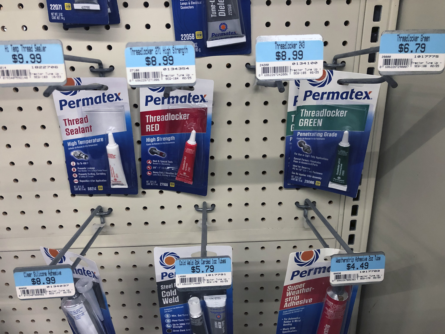 Photo of various threadlockers hanging on peghooks in a store display