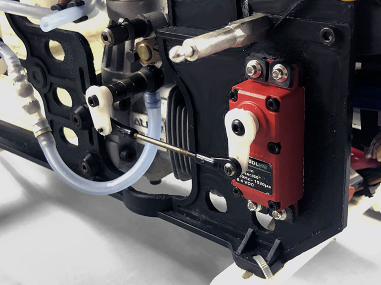 Close up of servo installed in helicopter sideframe for in-flight mixture adjustment