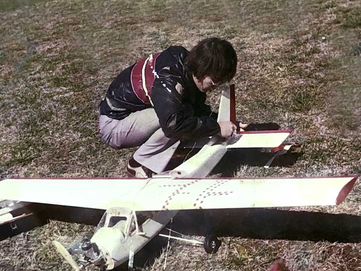 A young John Beech adjusting an elevator linkage on his Fox .59 powered Midwest Cardinal Squire model