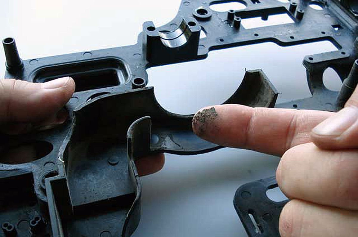 Close up of a dirty fingertip after wiping the inside of a model helicopter cooling fan shroud