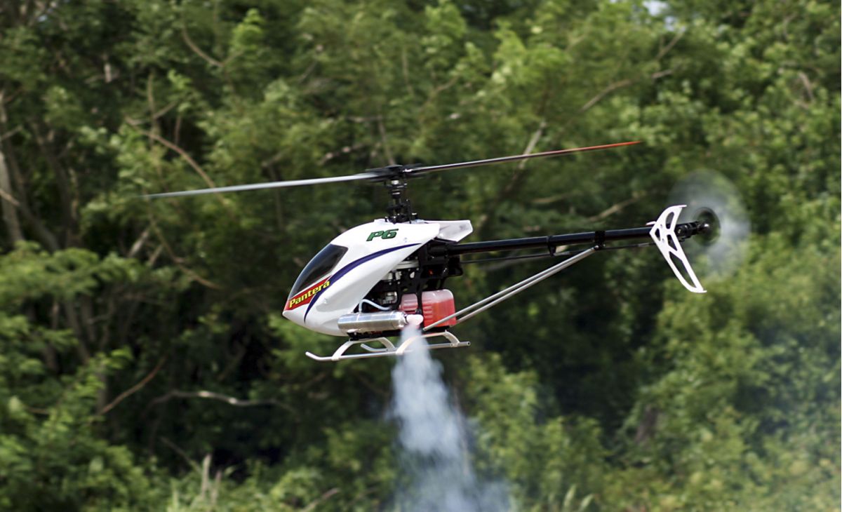 Medium shot of Pantera helicopter hovering skids at eyelevel as the fuel mixture is remotely adjusted